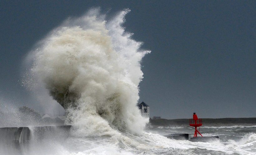 Huges waves break on the port of Lesconil, western France, on February 3, 2017. Storms will hit the northwest of the country, according to meteorologists. They have also given orange alert for the departments of Finistere, Cotes-d'Armor, Morbihan and Manche with gale force winds and strong waves, with the risk of flooding in some areas. / AFP PHOTO / FRED TANNEAU