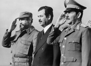 Iraqi vice-president Saddam Hussein (C), stands with Cuban President Fidel Castro (L) and Defense minister General Raul Castro (R), 30 January 1979 in Havana, during his visit to Cuba. / AFP PHOTO / PRENSA LATINA / -