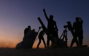 Fighters from the Free Syrian Army cheer and react as they fight against the Islamic State (IS) group jihadists on the outskirts of the northern Syrian town of Dabiq, on October 15, 2016. Turkish-backed fighters were advancing on the northern Syrian town of Dabiq, which has become a rallying cry for the Islamic State group as the prophesied scene of an end-of-days battle. Dabiq holds crucial ideological importance for IS because of a Sunni prophecy that states it will be the site of an end-of-times battle between Christian forces and Muslims. / AFP PHOTO / Nazeer al-Khatib / ALTERNATIVE CROP