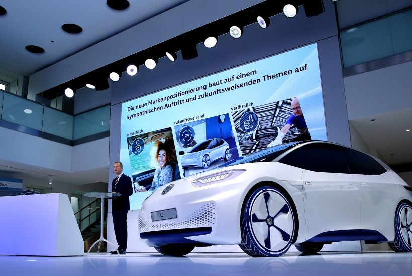 Volkswagen's chief of the brand Herbert Diess is pictured in front of the new Volkswagen I.D, the 100% electric car of Volkswagen during a press conference on November 22, 2016 in Wolfsburg, northern Germany. Herbert Diess sets out the German auto giant's long-term strategy after announcing the biggest revamp in its history last week, cutting 30,000 jobs to help it recover from the dieselgate emissions cheating scandal. / AFP PHOTO / RONNY HARTMANN