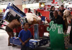 Thanksgiving Day shoppers push loaded up carts during the "Black Friday" sales at a Target store in Culver City, California on November 24, 2016. US retailers kicked off the unofficial start of the holiday retail season with sales that begin on the Thanksgiving holiday. / AFP PHOTO / Mark RALSTON