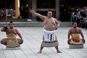 Newly promoted "Yokozuna" or sumo's grand champion, Kisenosato (C) performs a ring-entering ceremony beside Tachimochi, or sword carrier, Takayasu (L) and Tsuyuharai, or dew sweeper, Shohozan (R) at Meiji shrine in Tokyo on January 27, 2017 Japan's excruciating wait for a homegrown yokozuna ended when 30-year-old Kisenosato was promoted to the ancient sport's highest rank, the first Japan-born yokozuna in 19 years. / AFP PHOTO / TOSHIFUMI KITAMURA