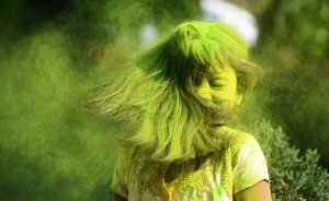 Indian students play with coloured powders as they celebrate 'holi' or the 'festival of colours' during a special function in Kolkata on March 12, 2017. / AFP PHOTO / Dibyangshu SARKAR