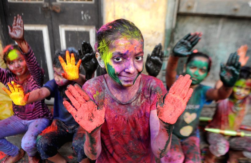 Indian revellers play with colours during Holi celebrations in Chennai on March 13, 2017. The Hindu festival of Holi, or the 'Festival of Colours' heralds the arrival of spring and the end of winter. / AFP PHOTO / ARUN SANKAR