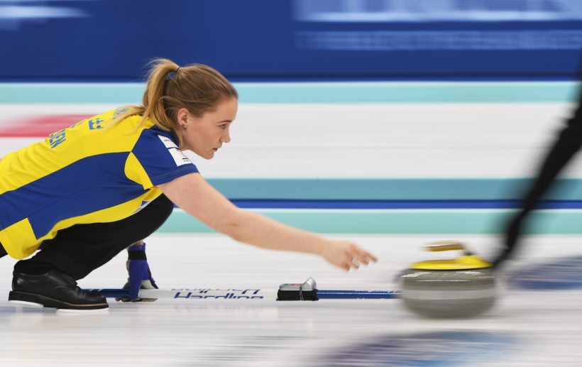 Sweden's Sara McManus releases the stone during their play-off against Scotland at the Women's Curling World Championships in Beijing on March 25, 2017. / AFP PHOTO / GREG BAKER