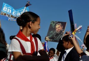 A schoolgirl looks at a poster showing an image of Cuban former President Fidel Castro, during celebrations marking the 156th anniversary of the birth of the national hero Jose Marti, at Revolution Square in Havana on January 28, 2009. AFP PHOTO/ADALBERTO ROQUE / AFP PHOTO / ADALBERTO ROQUE