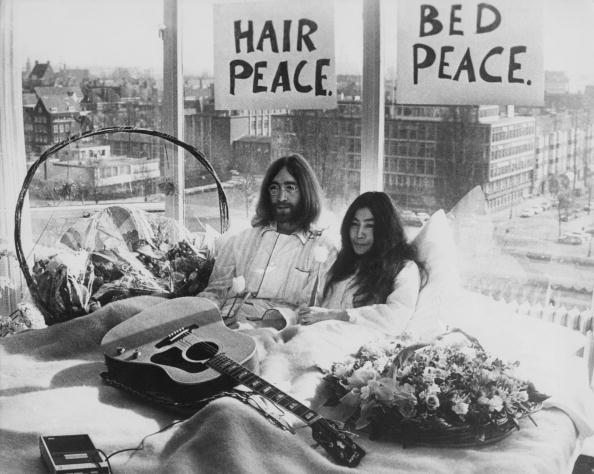 Beatle John Lennon (1940 � 1980) and his wife of a week Yoko Ono in their bed in the Presidential Suite of the Hilton Hotel, Amsterdam, 25th March 1969. The couple are staging a 'bed-in for peace' and intend to stay in bed for seven days 'as a protest against war and violence in the world'. (Photo by Keystone/Hulton Archive/Getty Images)