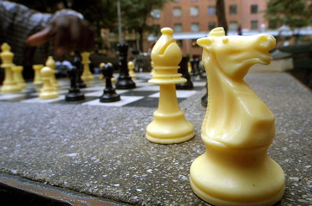 392475 08: Chess pieces sit next to the board during a round of chess July 26, 2001 at Washington Square Park in New York City. Chess legend Bobby Fischer played in this park which was later made famous in the film "Searching for Bobby Fischer.", (Photo by Mario Tama/Getty Images)