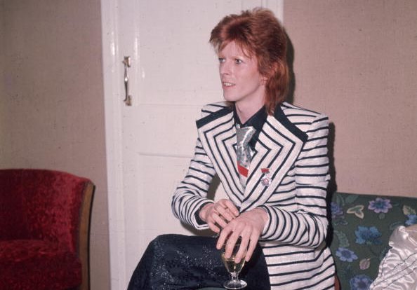 May 1973: In a black and white horizontally striped jacket with wide lapels glam rock star David Bowie. (Photo by Hulton Archive/Getty Images)