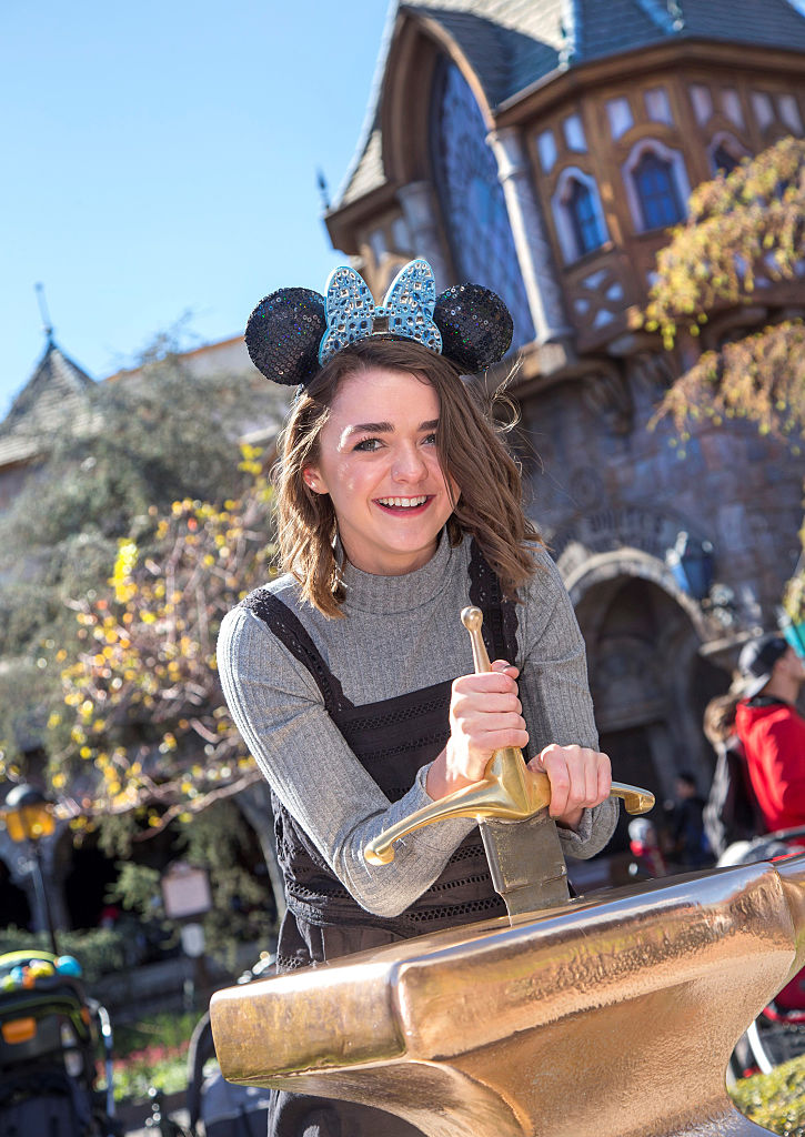 ANAHEIM, CA - FEBRUARY 01: In this handout photo provided by Disney Parks, "Game of Thrones" actress Maisie Williams attempts to remove the Sword in the Stone during her first visit to Disneyland Park February 1, 2016 in Anaheim, California. (Photo by Paul Hiffmeyer/Disneyland Resort via Getty Images)