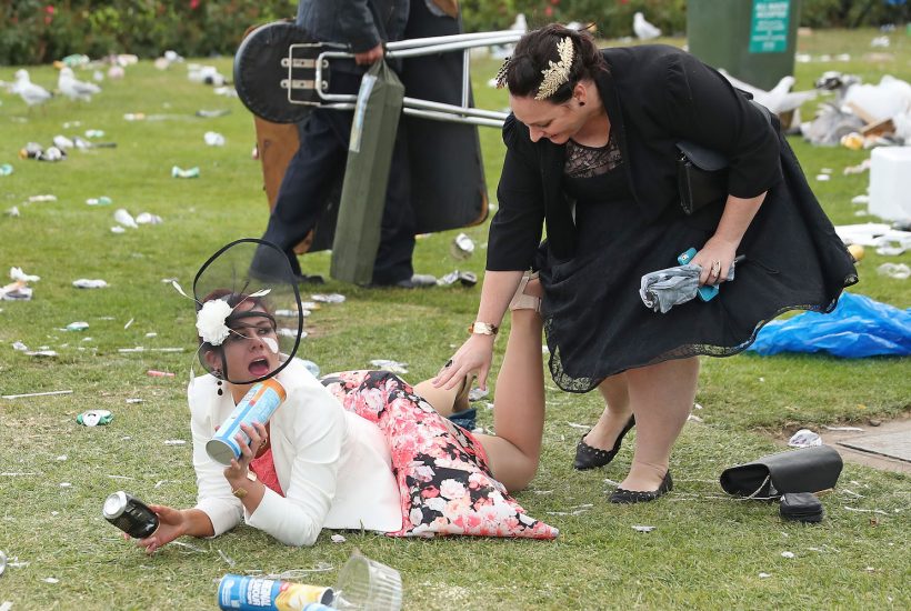 MELBOURNE, AUSTRALIA - NOVEMBER 01: A racegoers falls over following 2016 Melbourne Cup Day at Flemington Racecourse on November 1, 2016 in Melbourne, Australia. (Photo by Scott Barbour/Getty Images)