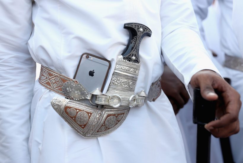 MUSCAT, MUSCAT - NOVEMBER 05: A dancer tucks his Apple iphone next to his traditional Omani dagger during an Omani cultural welcome ceremony outside the Sultan's Palace on the second day of a Royal tour of Oman on November 5, 2016 in Muscat, Oman. Prince Charles, Prince of Wales and Camilla, Duchess of Cornwall are on a Royal tour of the Middle East starting with Oman, then the UAE and finally Bahrain. (Photo by Chris Jackson/Getty Images)
