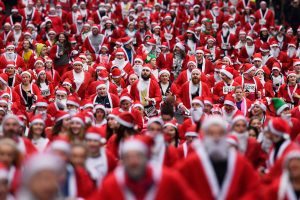 GLASGOW, SCOTLAND - DECEMBER 11: Over seven thousands of members of the public dressed as Santas make their way up St Vincent Street on December 11, 2016 in Glasgow, Scotland. The Santa Dash has been held since 2006 and this year is the 10th anniversary event, in total the event has raised over £100,000 for charities working in and around Glasgow. (Photo by Jeff J Mitchell/Getty Images)