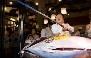 TOKYO, JAPAN - JANUARY 05: Kiyomura Co. President Kiyoshi Kimura poses with a fresh bluefin tuna before cutting it in front of one of the company's Sushi Zanmai sushi restaurants after the year's first auction at Tsukiji Market on January 5, 2017 in Tokyo, Japan. Kiyomura Co. bid the highest priced tuna weighing 212 kilogram (467.38 pound) for 74.2 million yen ($637,155) at the year's first auction. (Photo by Tomohiro Ohsumi/Getty Images)