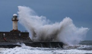 REDCAR, UNITED KINGDOM - JANUARY 13: Huge waves crash over the lighthouse at an area known as South Gare on January 13, 2017 in Redcar, United Kingdom. The Met Office has issued a yellow be aware warning for much of the UK, as snow, ice and winds are expected to cause disruption until late on Friday. It comes amid severe flood warnings issued along the eastern coast of England, as it braces for a storm surge. (Photo by Ian Forsyth/Getty Images)