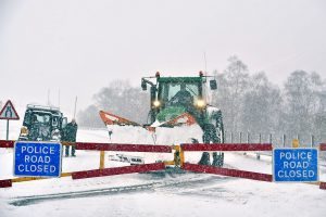 SPITTAL OF GLENSHEE, UNITED KINGDOM - JANUARY 13: A tractor with a snow plough attached clears the A93 on January 13, 2017 in Spital of Glenshee, United Kingdom. The Met Office has issued a yellow be aware warning for much of the UK, as snow, ice and winds are expected to cause disruption until late on Friday. It comes amid severe flood warnings issued along the eastern coast of England, as it braces for a storm surge. (Photo by Jeff J Mitchell/Getty Images)