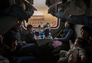 BEIJING, CHINA - JANUARY 25: A Chinese family rides on a crowded train between Beijing and Shijiazhuang, on January 25, 2017 in Hebei province, northern China. Millions of Chinese will travel home to visit families in what is often called the largest human migration during the Spring Festival holiday period that begins with the Lunar New Year on January 28, 2017. (Photo by Kevin Frayer/Getty Images)