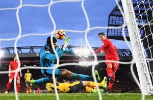 LIVERPOOL, ENGLAND - MARCH 04: Roberto Firmino of Liverpool (R) scores his sides first goal past Petr Cech of Arsenal (L) during the Premier League match between Liverpool and Arsenal at Anfield on March 4, 2017 in Liverpool, England. (Photo by Laurence Griffiths/Getty Images)
