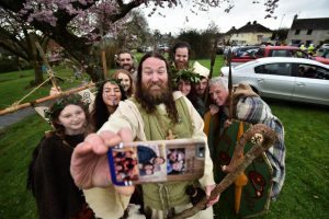 DOWNPATRICK, NORTHERN IRELAND - MARCH 17: Saint Patrick, played by actor Marty Burns takes a selfie along with members of the Magnus Vikings Association before they part in the cross community Saint Patrick's Day parade on March 17, 2017 in Downpatrick, Northern Ireland. Tradition holds that Saint Patrick and his companions landed at the mouth of the Slaney river, a few miles from Down Cathedral, in 432 AD. From here Patrick travelled extensively spreading the teachings of Christianity before his death on 17th March 461 AD. He is buried at nearby Down Cathedral. (Photo by Charles McQuillan/Getty Images)