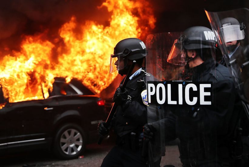 WASHINGTON, DC - JANUARY 20: Police and demonstrators clash in downtown Washington after a limo was set on fire following the inauguration of President Donald Trump on January 20, 2017 in Washington, DC. Washington and the entire world have watched the transfer of the United States presidency from Barack Obama to Donald Trump, the 45th president. (Photo by Spencer Platt/Getty Images)